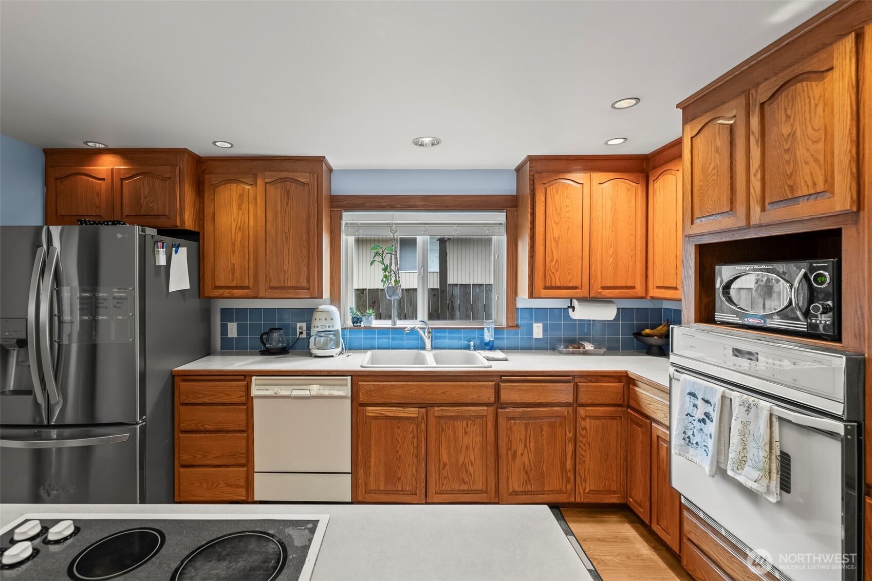 363 Del Monte Avenue Fircrest, WA 98466 - Photo 14 of 39 a kitchen with a sink stove and refrigerator