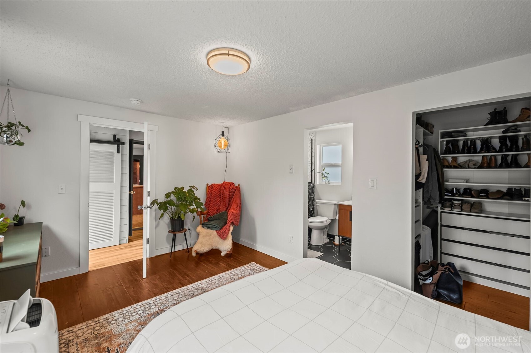 363 Del Monte Avenue Fircrest, WA 98466 - Photo 19 of 39 a bedroom with a bed and a bookshelf with wooden floor