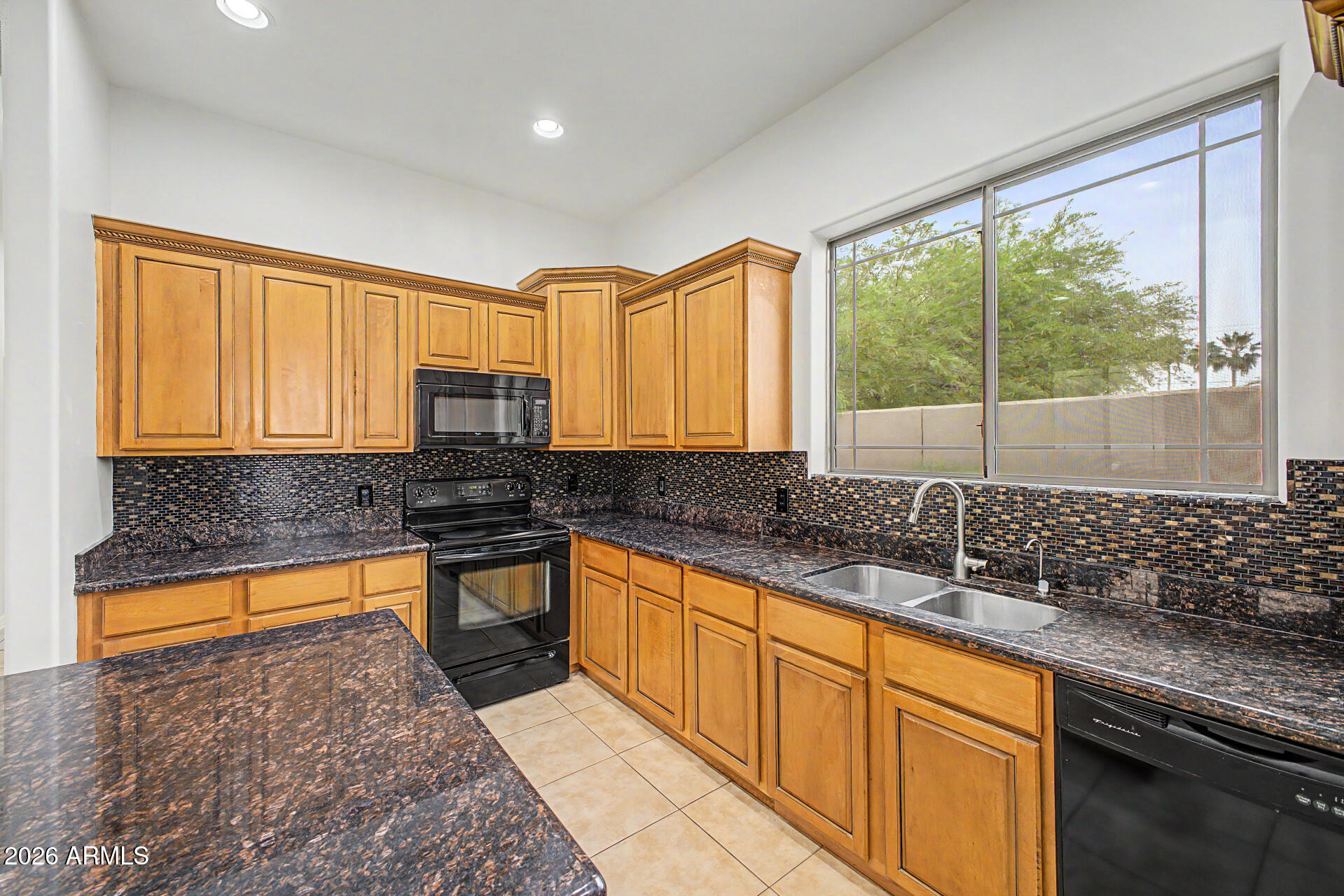 6202 East McKellips Road, Unit 19 Mesa, AZ 85215 - Photo 13 of 37 a kitchen with stainless steel appliances granite countertop sink stove and cabinets