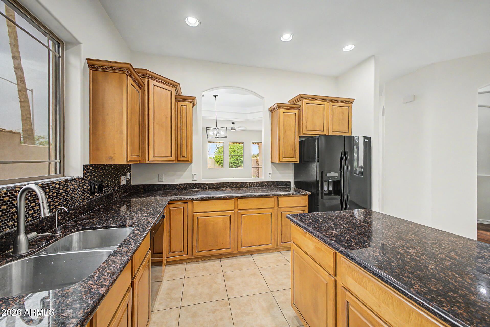 6202 East McKellips Road, Unit 19 Mesa, AZ 85215 - Photo 14 of 37 a kitchen with granite countertop a sink a counter top space and stainless steel appliances
