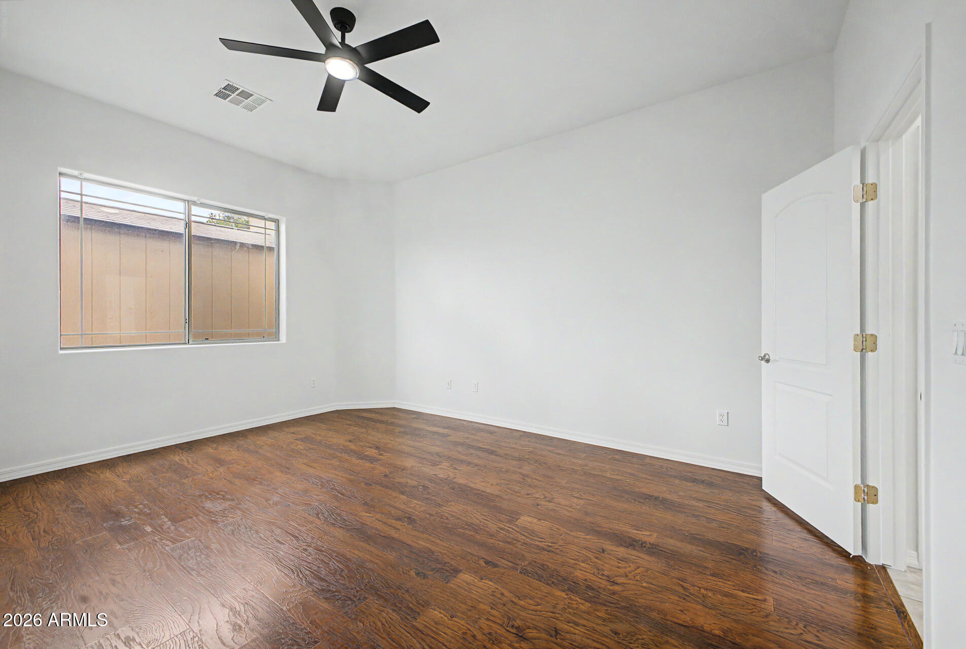 6202 East McKellips Road, Unit 19 Mesa, AZ 85215 - Photo 15 of 37 an empty room with wooden floor closet and windows