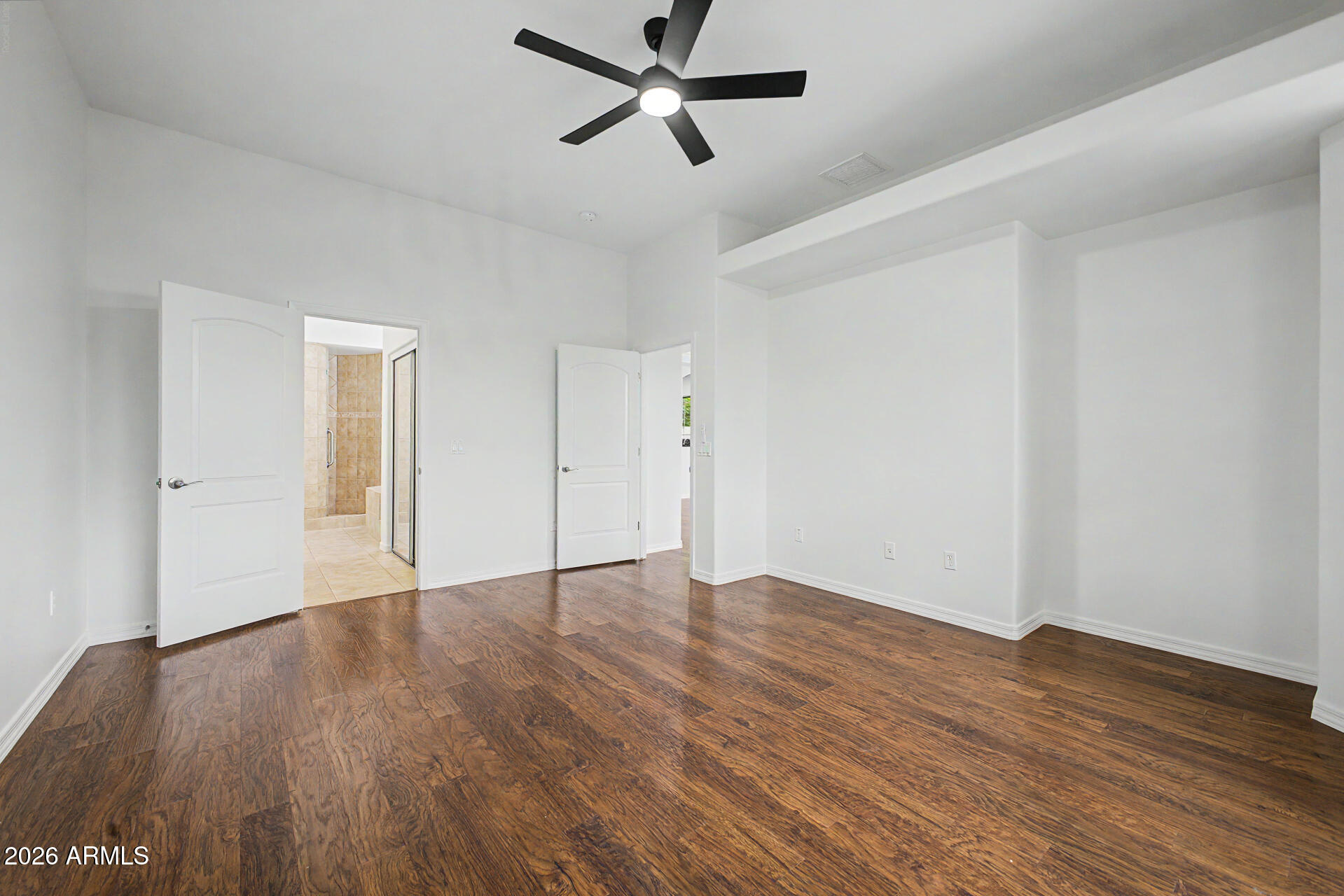 6202 East McKellips Road, Unit 19 Mesa, AZ 85215 - Photo 17 of 37 an empty room with wooden floor and windows