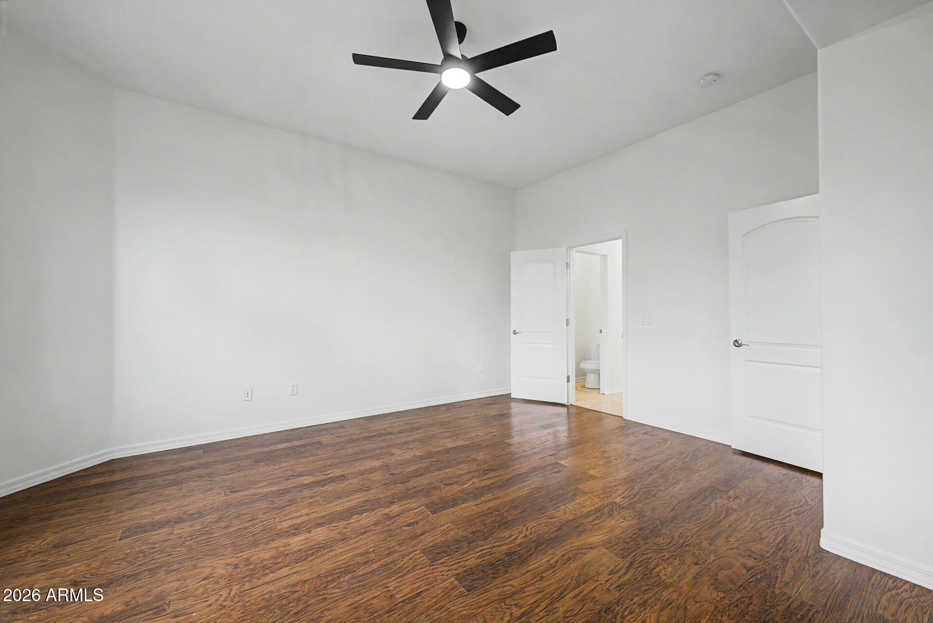 6202 East McKellips Road, Unit 19 Mesa, AZ 85215 - Photo 18 of 37 an empty room with wooden floor and windows
