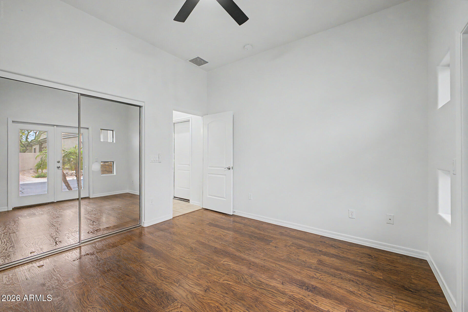 6202 East McKellips Road, Unit 19 Mesa, AZ 85215 - Photo 25 of 37 a view of empty room with wooden floor and fan