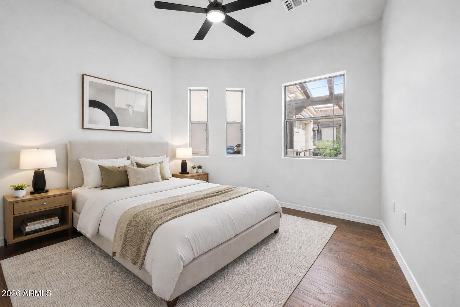 6202 East McKellips Road, Unit 19 Mesa, AZ 85215 - Photo 27 of 37 a spacious bedroom with a bed and a painting on the wall