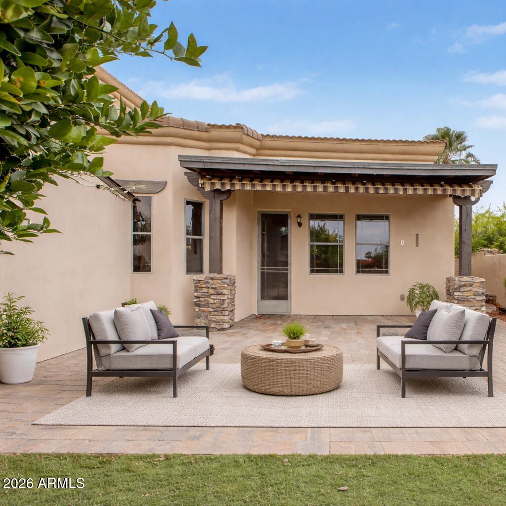 6202 East McKellips Road, Unit 19 Mesa, AZ 85215 - Photo 37 of 37 a view of a patio with couches table and chairs and potted plants