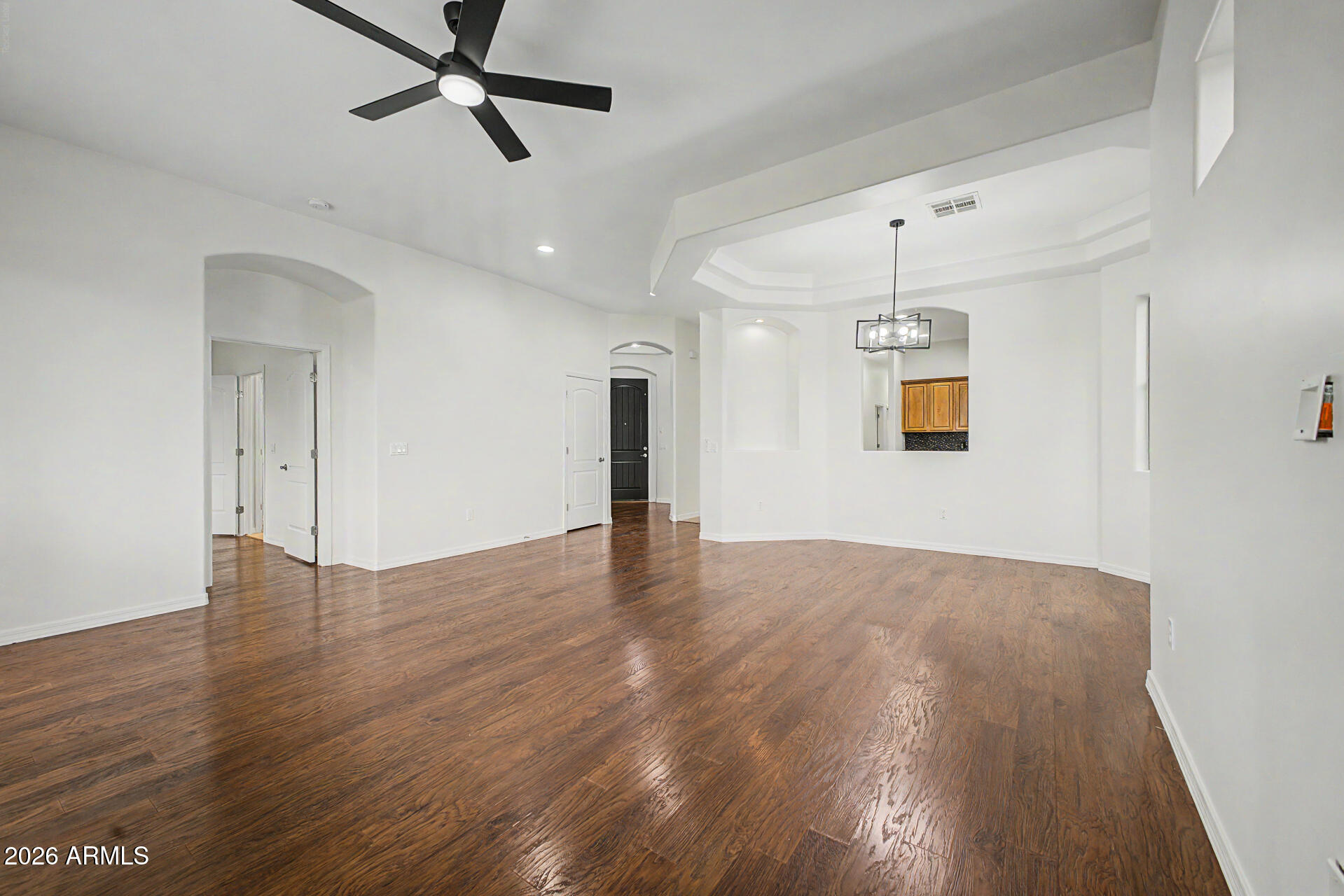 6202 East McKellips Road, Unit 19 Mesa, AZ 85215 - Photo 5 of 37 a view of an empty room with wooden floor