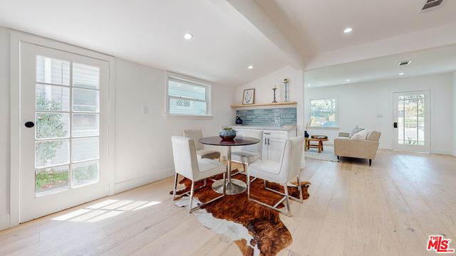 a dining room with furniture and wooden floor