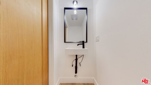 a bedroom with a large bed and a wooden floor