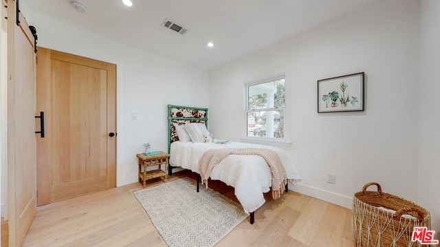 a bedroom with a bed and a window