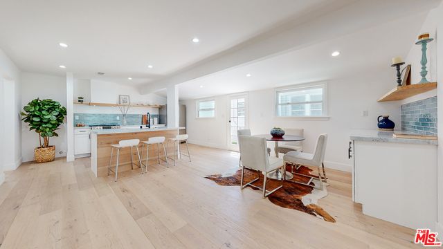 a living room with furniture and a dining table with kitchen view
