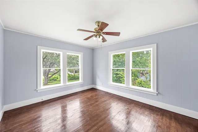 a view of a room with a window and wooden floor