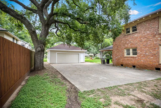 a front view of a house with a yard and a garage