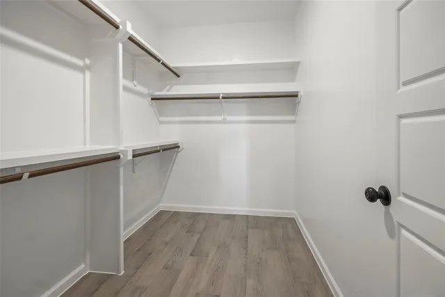 a view of walk in closet with empty racks