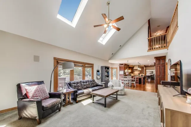 a view of a livingroom with furniture chandelier front door and wooden floor