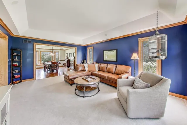 a spacious bedroom with a bed couch and windows