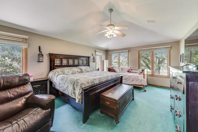 a bedroom with a bed and a flat tv screen on dresser