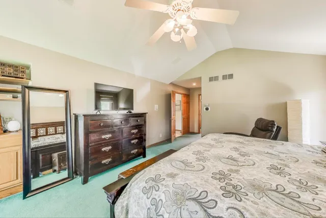 a spacious bedroom with a bed and large windows