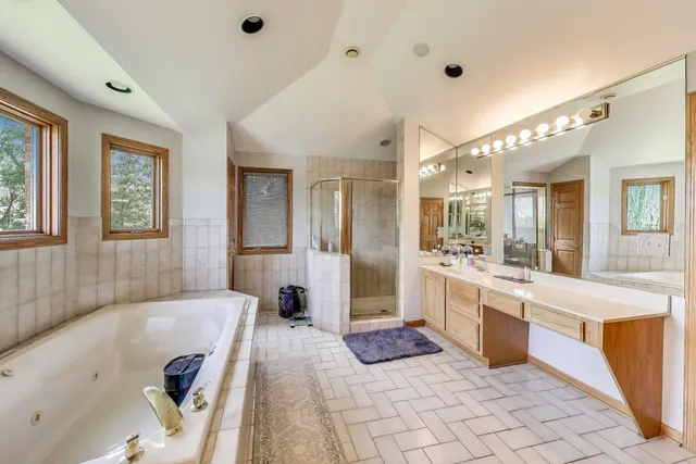 a bedroom with a bed a lamp and mirror