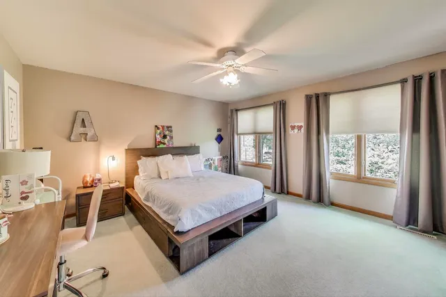 a bedroom with a large bed and a window