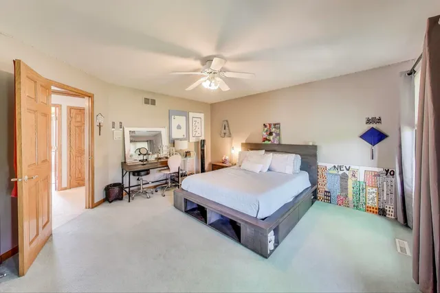 a bedroom with a bed and a dresser