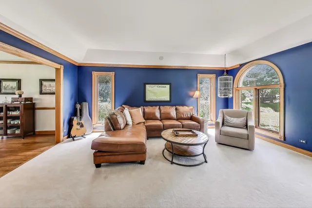 a living room with furniture fireplace and floor to ceiling window
