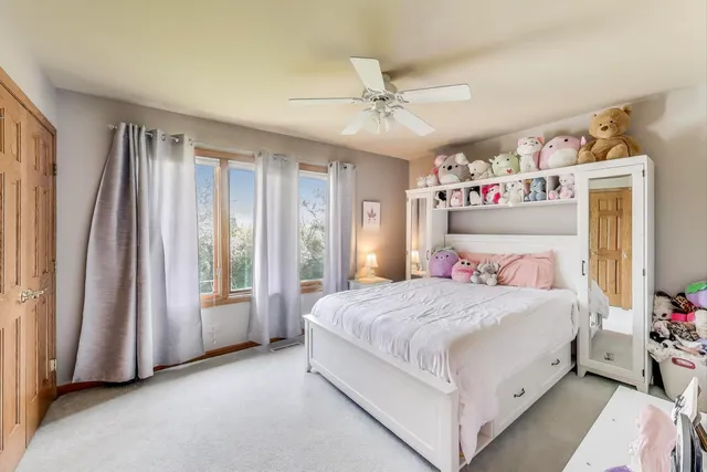 a view of a roof deck with table and chairs a barbeque with wooden floor and fence