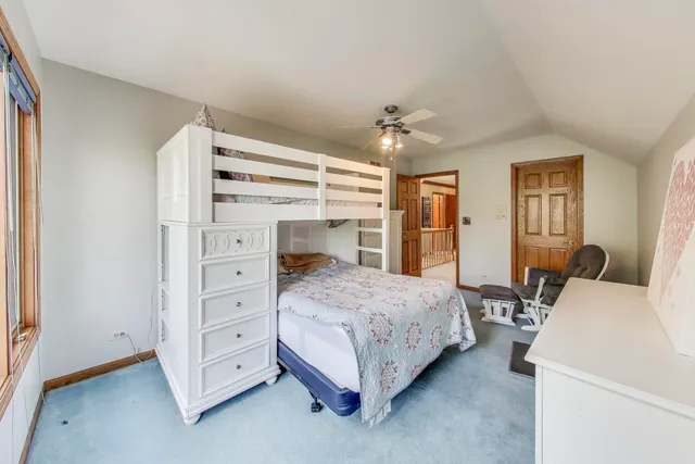 a view of a patio with table and chairs with wooden floor and fence