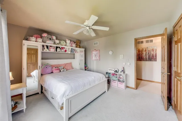 a view of patio with table and chairs under an umbrella with wooden floor