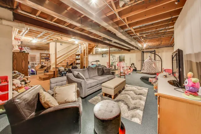 a view of a house with a big yard potted plants and large tree
