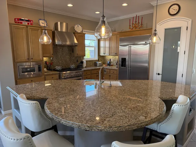 a bathroom with a granite countertop toilet sink and mirror