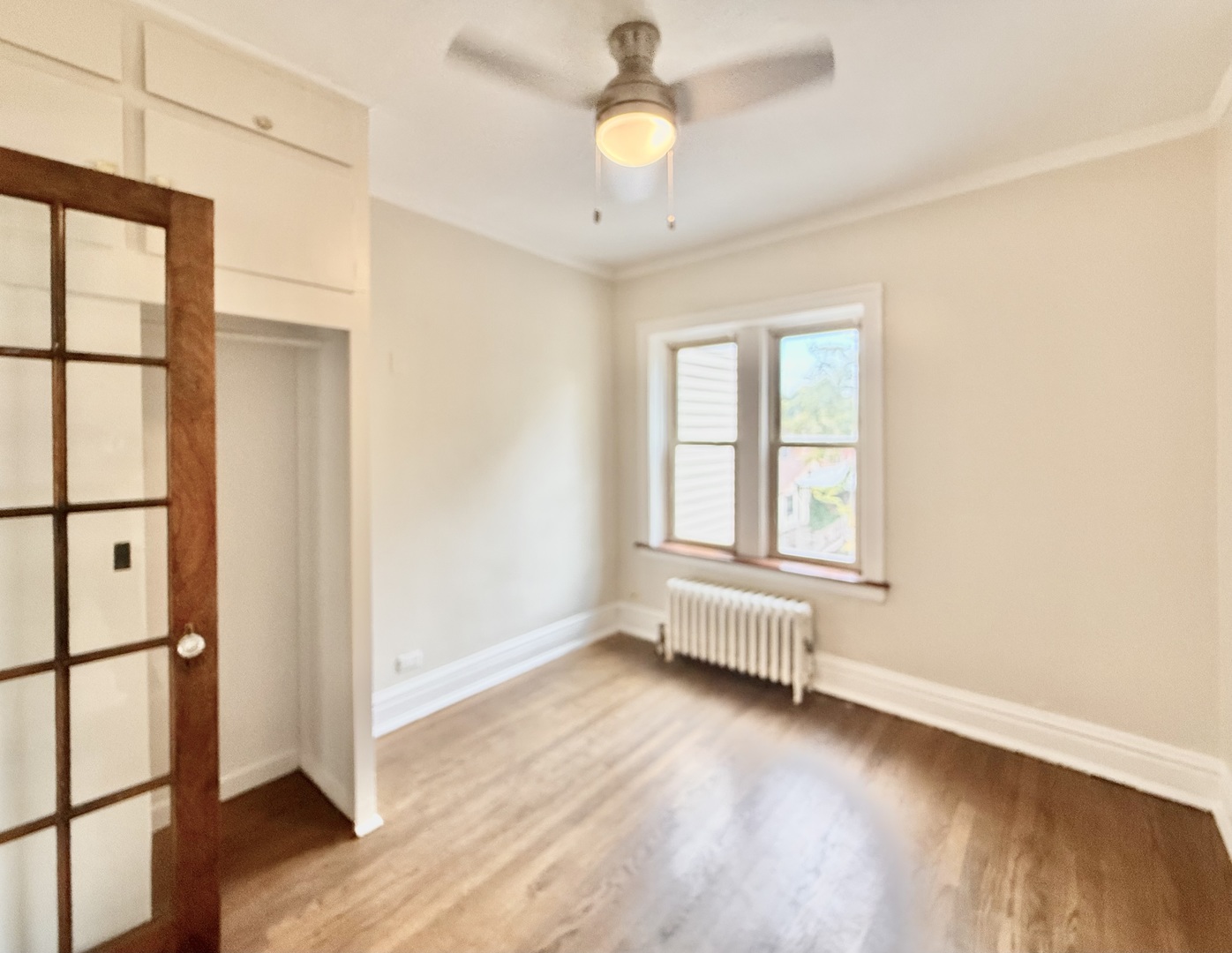 314 North Maple Avenue, Unit 3S Oak Park, IL 60302 - Photo 16 of 22 an empty room with wooden floor fan and windows