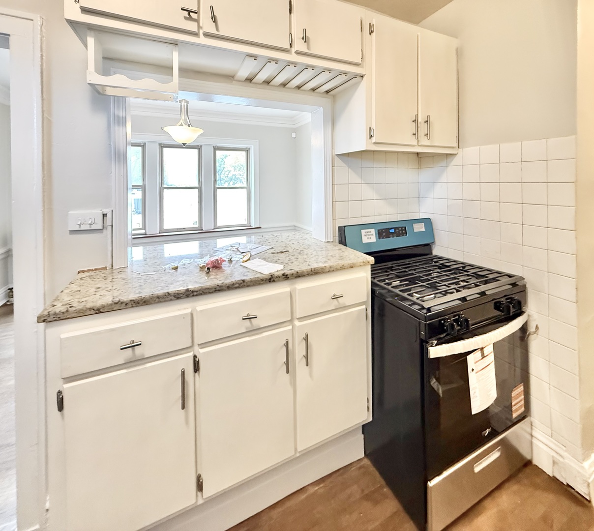 314 North Maple Avenue, Unit 3S Oak Park, IL 60302 - Photo 20 of 22 a kitchen with granite countertop white cabinets and white appliances