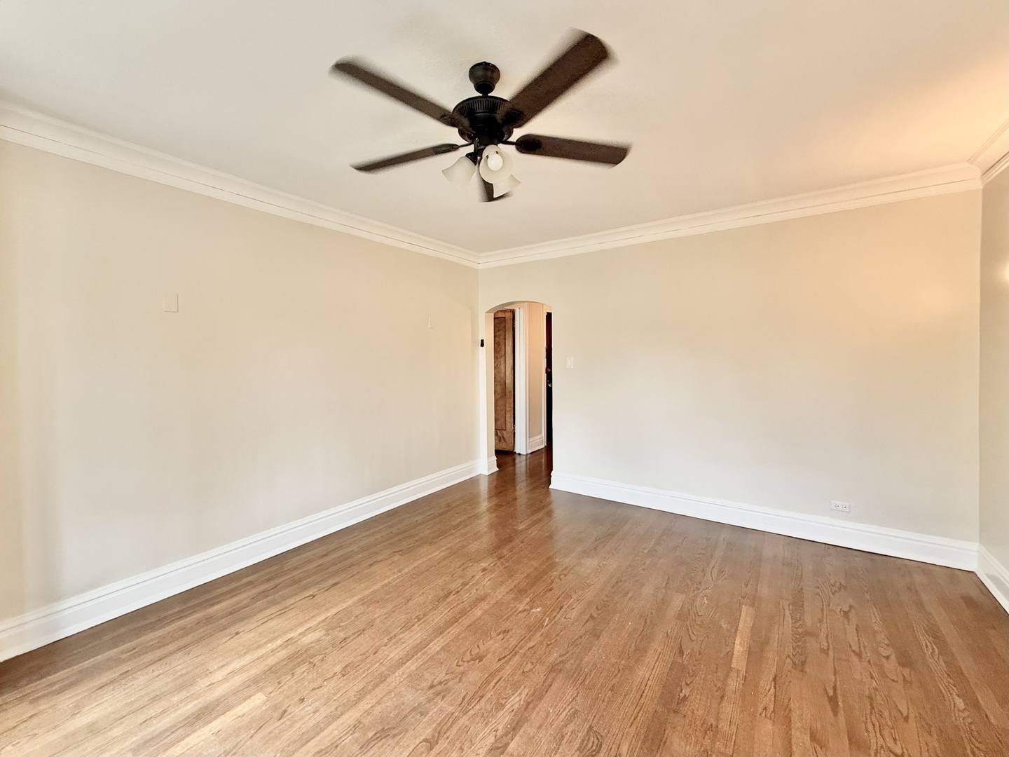 314 North Maple Avenue, Unit 3S Oak Park, IL 60302 - Photo 4 of 22 an empty room with wooden floor and a ceiling fan