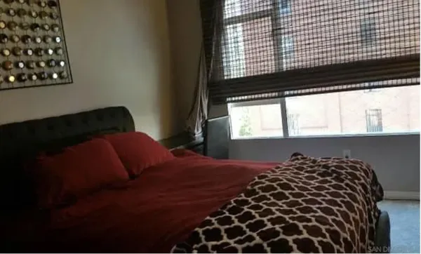 a bedroom with a bed and a window
