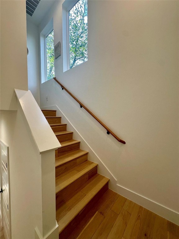 3417 Elija Street, Unit 2 Austin, TX 78745 - Photo 12 of 28 Stairway featuring hardwood / wood-style floors and a high ceiling