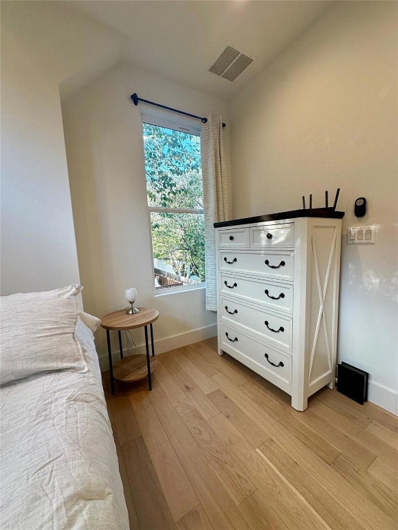 3417 Elija Street, Unit 2 Austin, TX 78745 - Photo 19 of 28 Bedroom with vaulted ceiling and light wood-type flooring