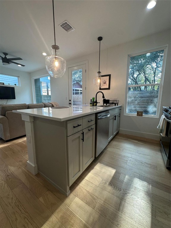 3417 Elija Street, Unit 2 Austin, TX 78745 - Photo 28 of 28 Kitchen with decorative light fixtures, recessed lighting, open floor plan, appliances with stainless steel finishes, and light stone counters