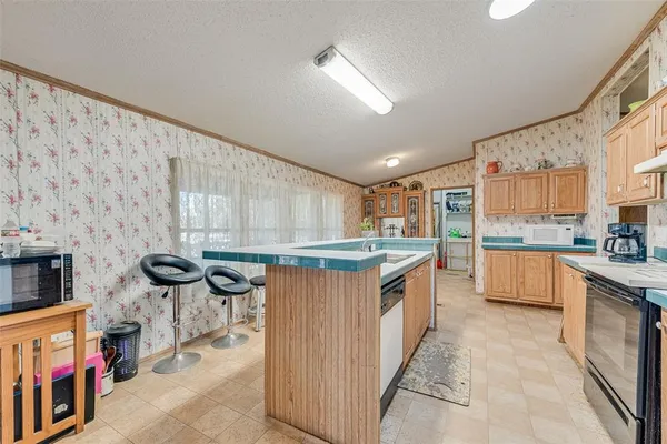 a kitchen with stainless steel appliances a stove a sink and a refrigerator