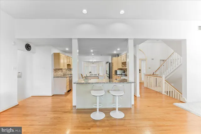 a kitchen with stainless steel appliances granite countertop a refrigerator a oven and a sink