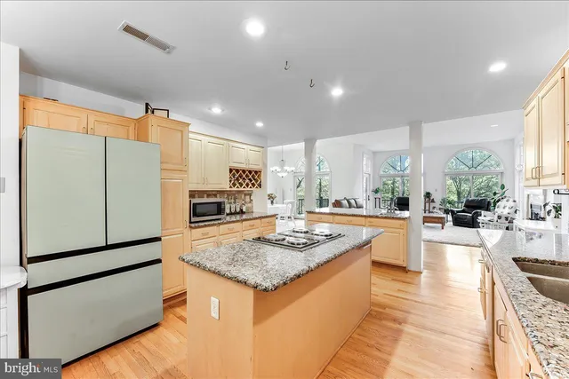 a living room with furniture chandelier and a large window