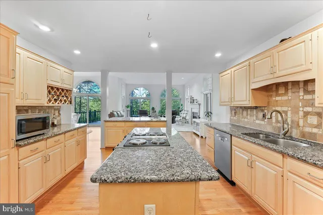 a living room with furniture a fireplace and a large window