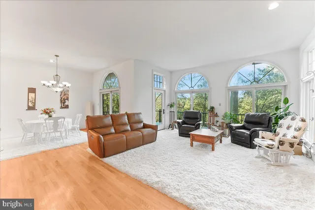 a living room with furniture fireplace and a large window