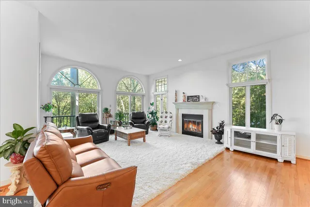 a living room with furniture wooden floor and a large window