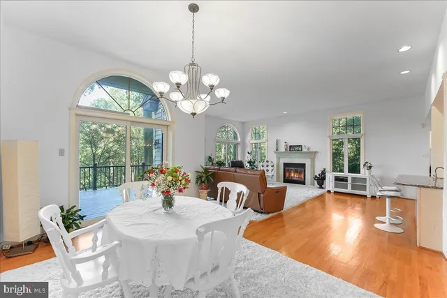 a spacious bedroom with a bed table and a window
