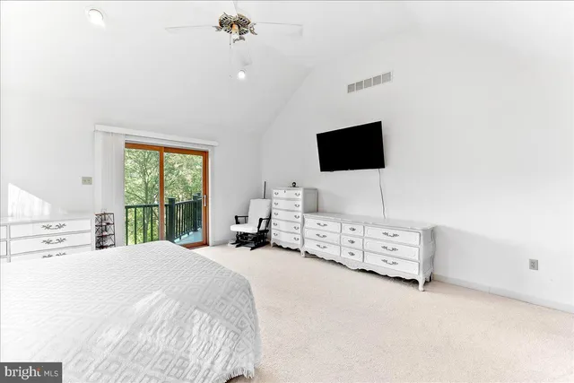 a bedroom with a bed and flat screen tv