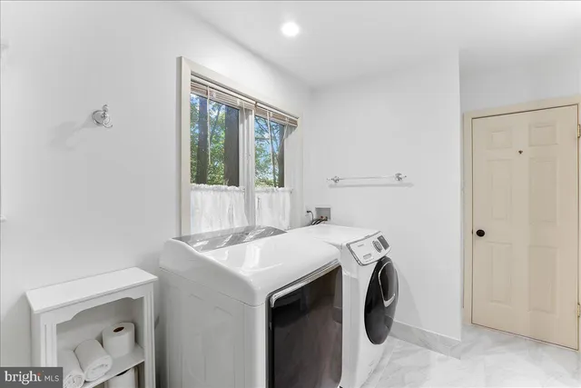 a bathroom with a toilet a sink a mirror and vanity