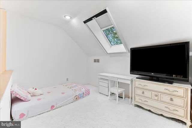 a view of walk in closet with clothes