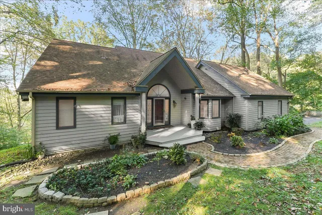 a view of a house with backyard tub and sitting area