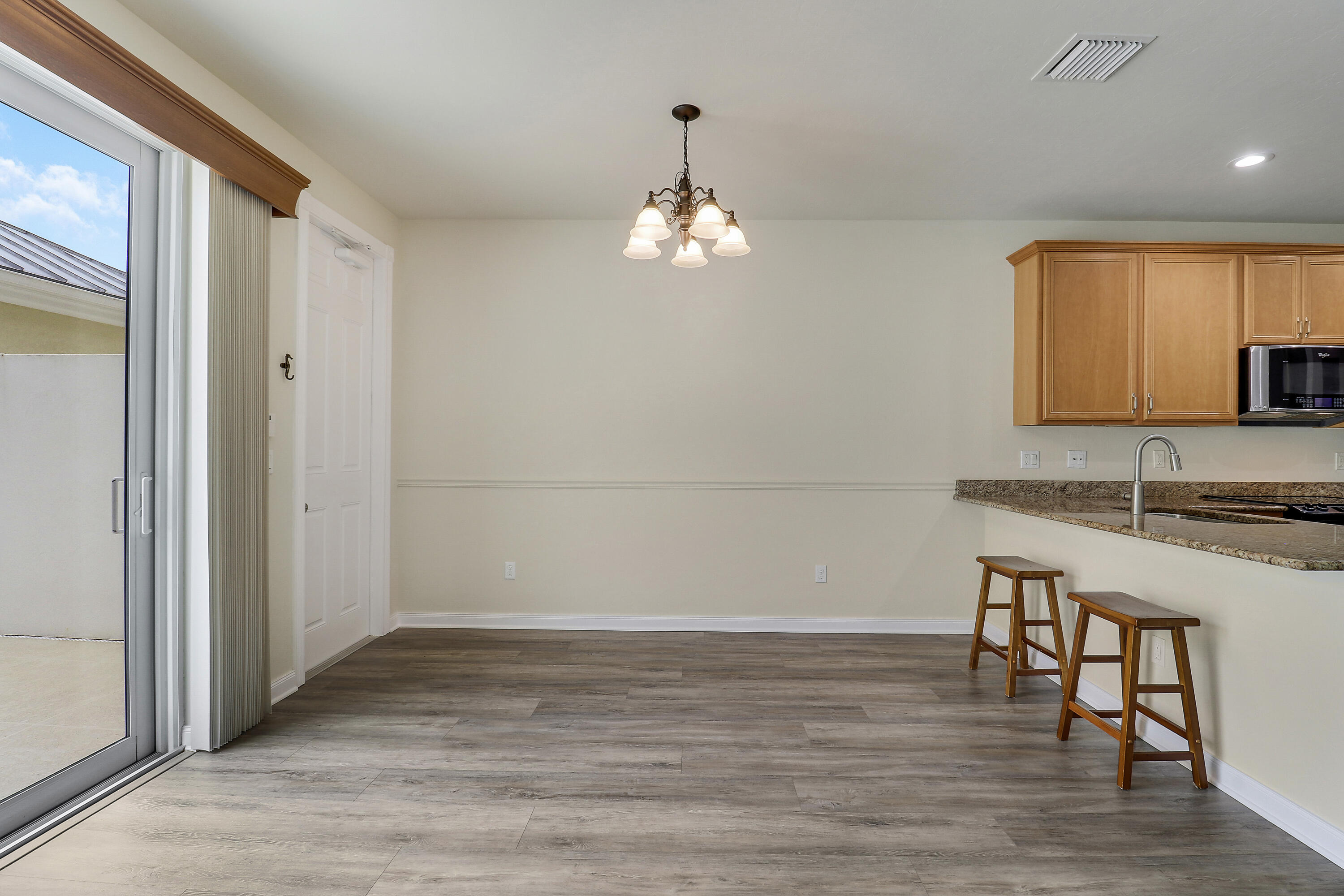 1043 Key Largo Street Jupiter, FL 33458 - Photo 12 of 46 wooden floor in an empty room with a window